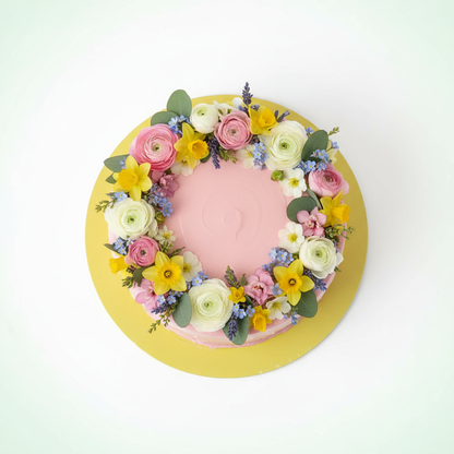 Gelbe Tortenplatte mit frühlingshafter Torte Draufsicht